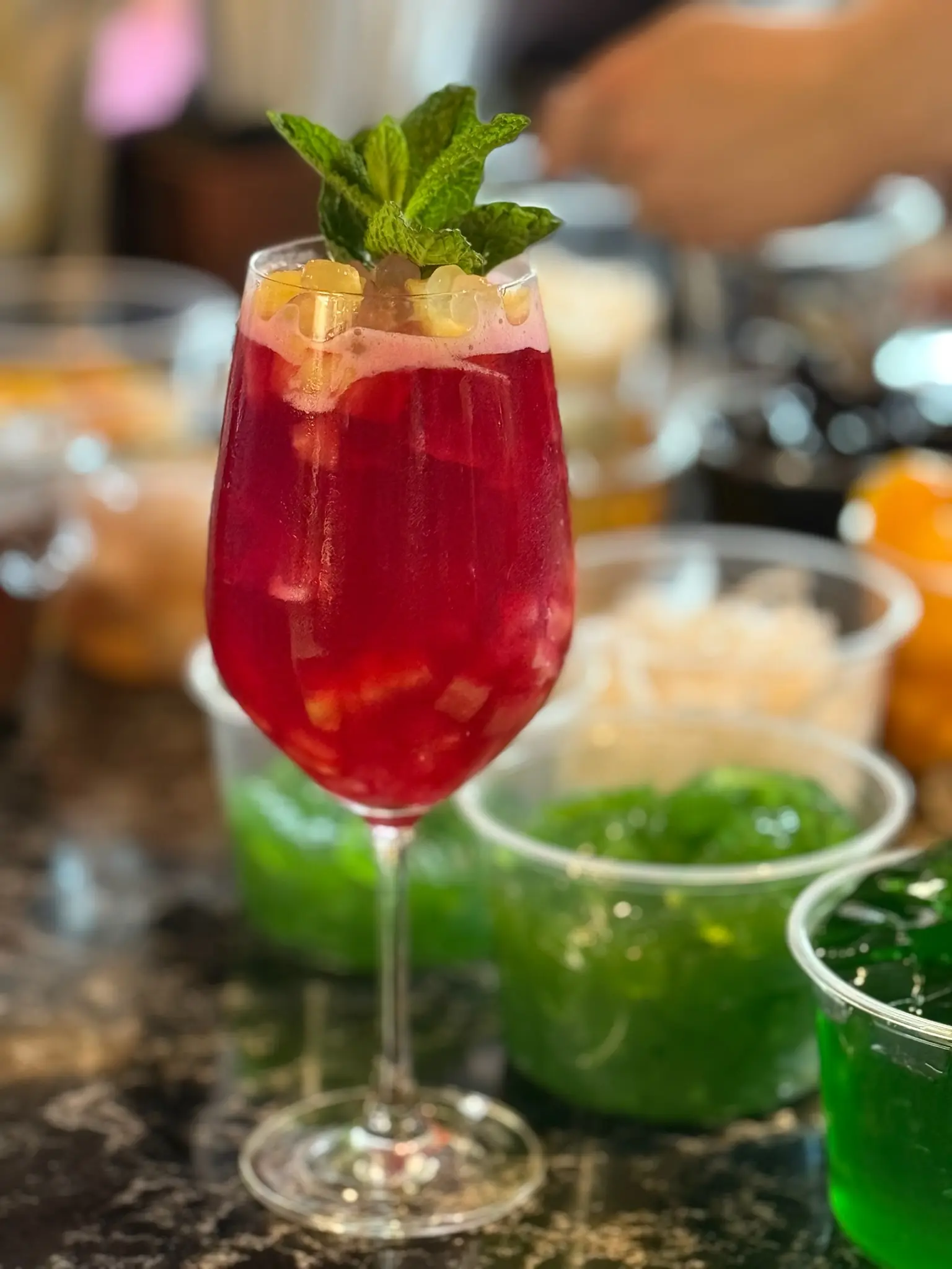 Cocktail and prepped garnishes at the bar station