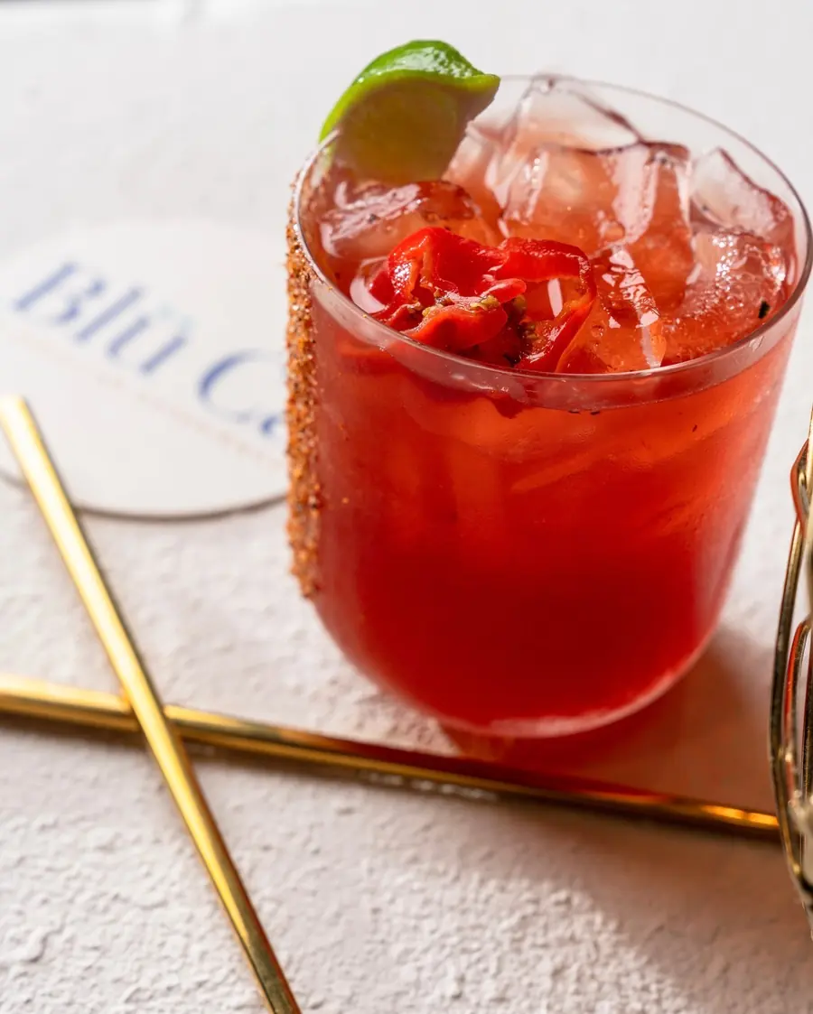Spicy red cocktail with a chili rim