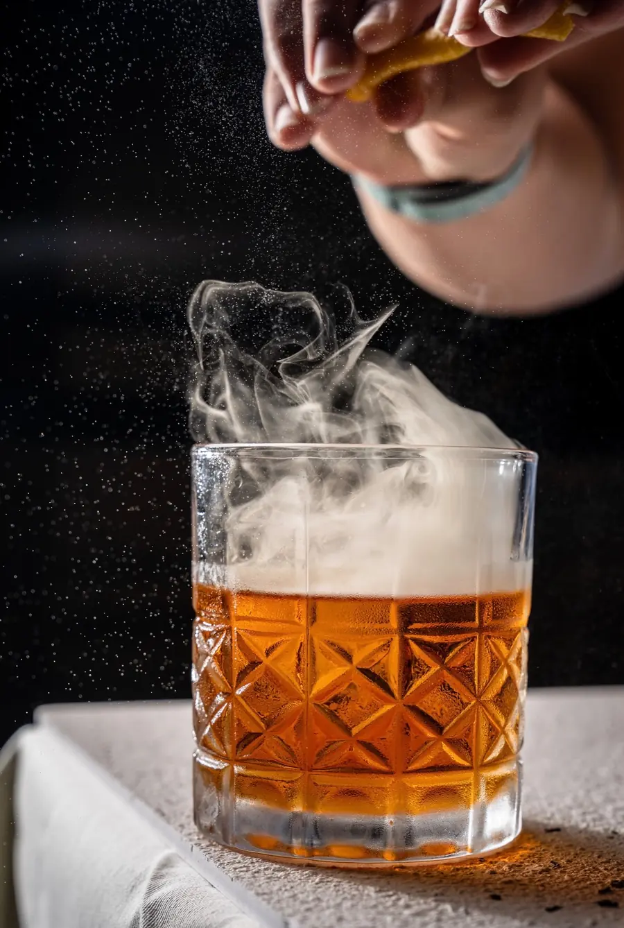 Smoked old fashioned being finished at the bar